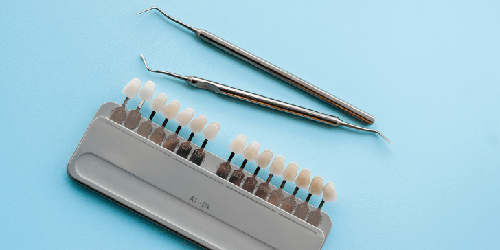 Tools used for dental procedures, including a shade guide for selecting tooth color