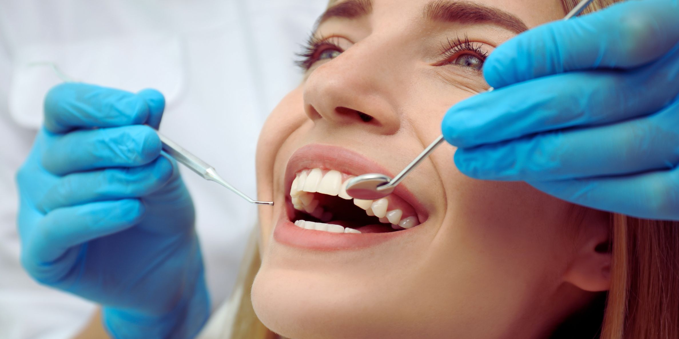 Dentist performing cosmetic dental treatment on a patient